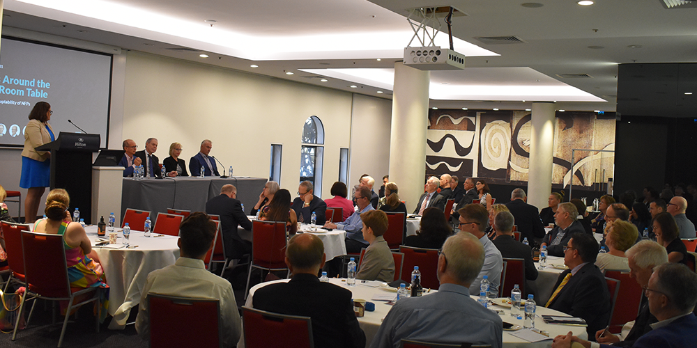 Attendees listen to the panel of speakers at Windsor Group's Sparks Around the Board Room Table event